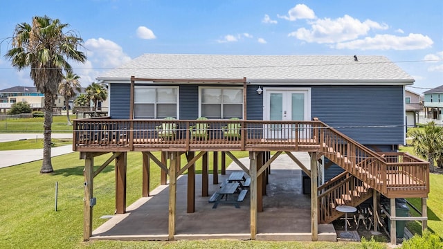 4039 San Jacinto Dr, Galveston, TX 77554 - back of property featuring a patio area, french doors, a yard, a deck, and roof with shingles