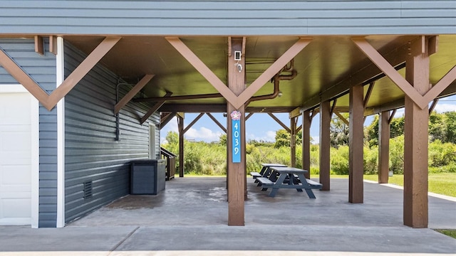 4039 San Jacinto Dr, Galveston, TX 77554 - view of patio featuring a carport
