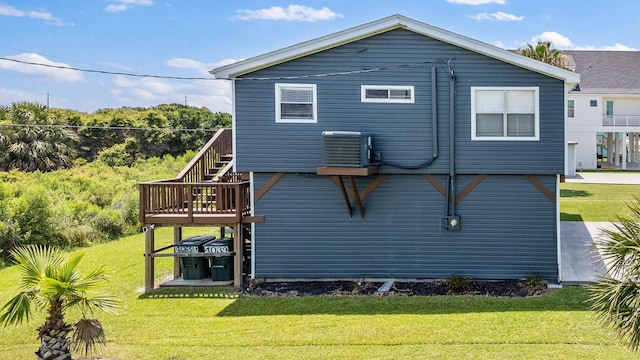 4039 San Jacinto Dr, Galveston, TX 77554 - back of house featuring a lawn, stairway, and a deck