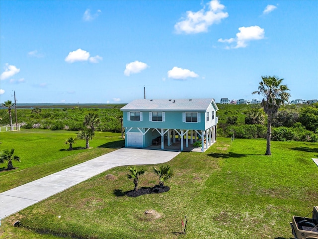 4039 San Jacinto Dr, Galveston, TX 77554 - view of front of house with driveway, a front lawn, and a carport