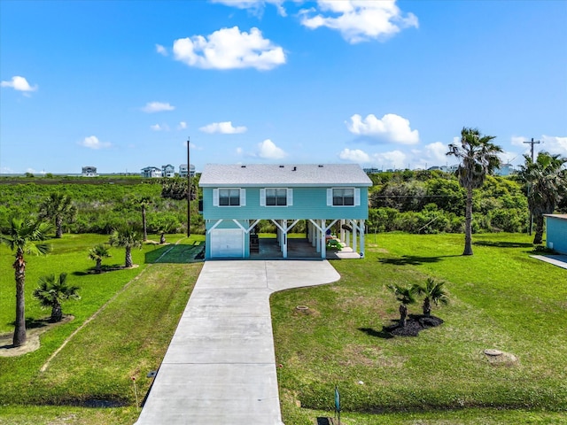 4039 San Jacinto Dr, Galveston, TX 77554 - view of front of house with driveway, a carport, an attached garage, and a front yard