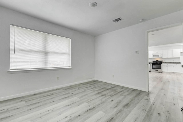 408 Commanche Rd, Conroe, TX 77316 - empty room with light wood-style floors and a smoke detector