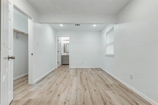 408 Commanche Rd, Conroe, TX 77316 - unfurnished bedroom featuring light wood-style flooring, a walk in closet, recessed lighting, and connected bathroom