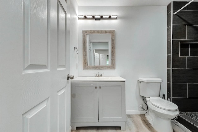 408 Commanche Rd, Conroe, TX 77316 - full bathroom with tiled shower, vanity, and wood finished floors
