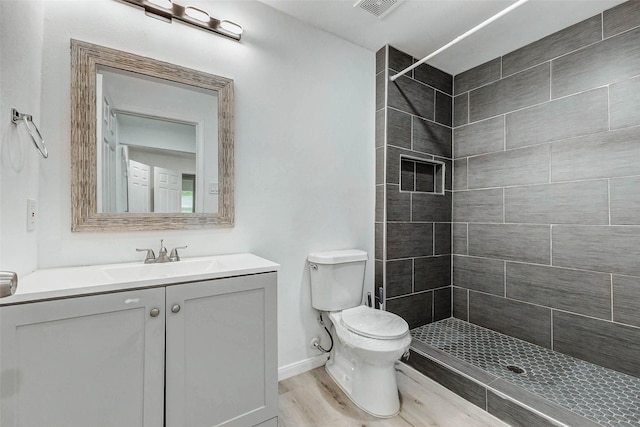 408 Commanche Rd, Conroe, TX 77316 - bathroom featuring a tile shower, vanity, and wood finished floors