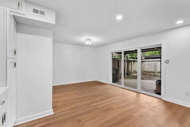 8124 Fondren Rd Unit 8124, Houston, TX 77074 - empty room with light wood-style flooring and recessed lighting