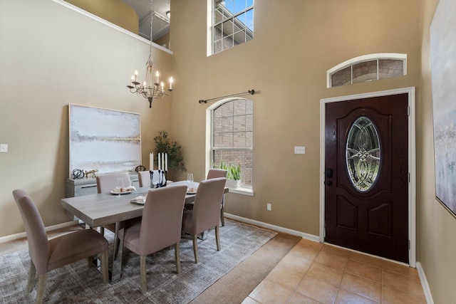 28210 Slatestone Ln, Spring, TX 77386 - dining space with a chandelier, healthy amount of natural light, a towering ceiling, and tile patterned floors
