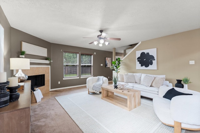 28210 Slatestone Ln, Spring, TX 77386 - living area with carpet, ceiling fan, a tile fireplace, and a textured ceiling