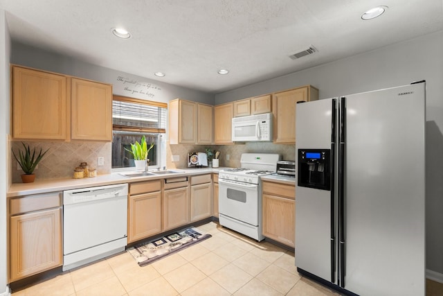 28210 Slatestone Ln, Spring, TX 77386 - kitchen with white appliances, light brown cabinets, light countertops, backsplash, and recessed lighting