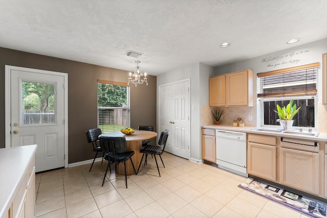 28210 Slatestone Ln, Spring, TX 77386 - kitchen with dishwasher, light brown cabinets, light countertops, a chandelier, and decorative backsplash