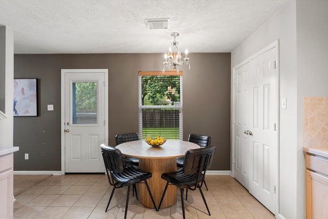 28210 Slatestone Ln, Spring, TX 77386 - dining space featuring light tile patterned floors, a chandelier, and a textured ceiling