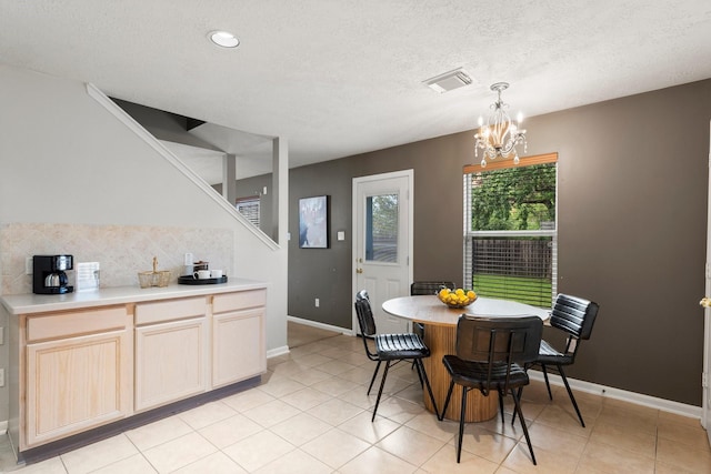 28210 Slatestone Ln, Spring, TX 77386 - dining area with a chandelier, light tile patterned flooring, a textured ceiling, and recessed lighting