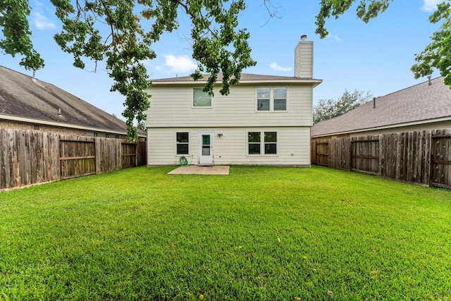 28210 Slatestone Ln, Spring, TX 77386 - rear view of house with a chimney, a fenced backyard, and a patio