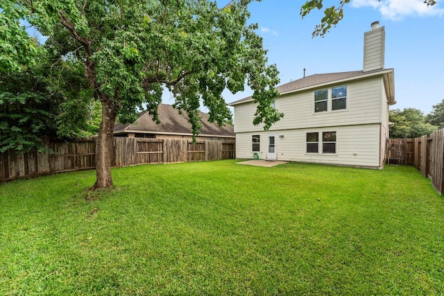 28210 Slatestone Ln, Spring, TX 77386 - rear view of house with a chimney, a fenced backyard, and a patio