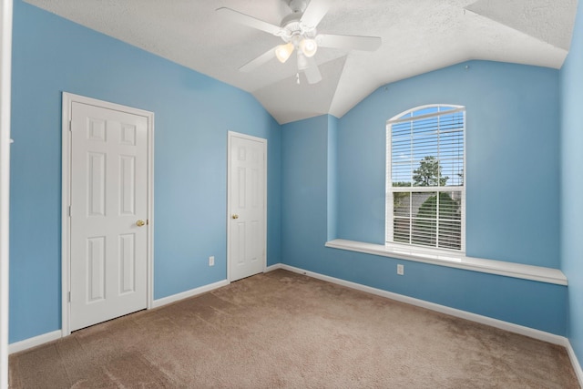 28210 Slatestone Ln, Spring, TX 77386 - unfurnished bedroom featuring carpet flooring, lofted ceiling, a textured ceiling, and a ceiling fan