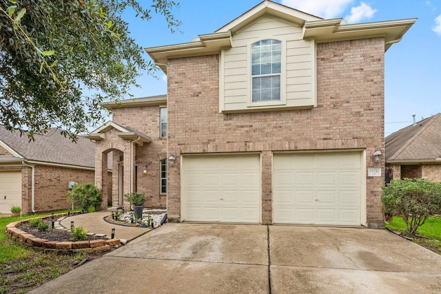28210 Slatestone Ln, Spring, TX 77386 - view of front of house featuring an attached garage, concrete driveway, and brick siding