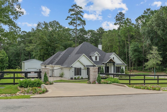 206 Rim Rock Rd, Huntsville, TX 77340 - view of front of home with board and batten siding, a fenced front yard, a chimney, roof with shingles, and a gate