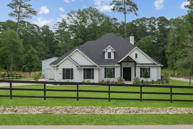 206 Rim Rock Rd, Huntsville, TX 77340 - modern farmhouse style home with board and batten siding, a shingled roof, a chimney, a fenced front yard, and a garage