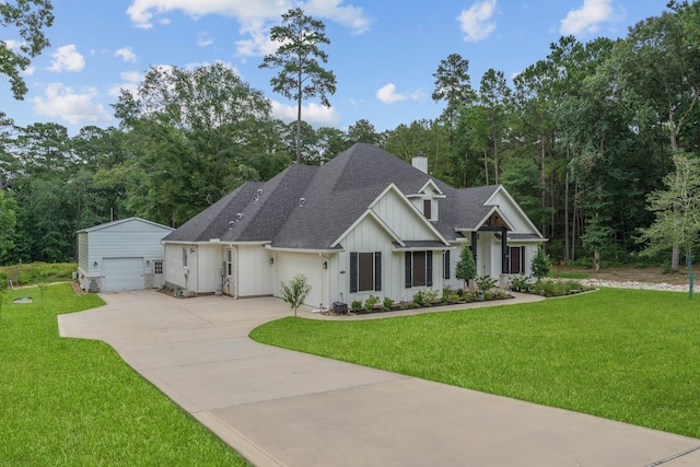 206 Rim Rock Rd, Huntsville, TX 77340 - view of front facade with board and batten siding, an outbuilding, roof with shingles, a chimney, and driveway