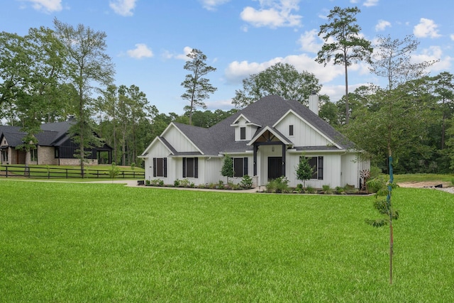 206 Rim Rock Rd, Huntsville, TX 77340 - modern farmhouse featuring board and batten siding, a chimney, and a shingled roof