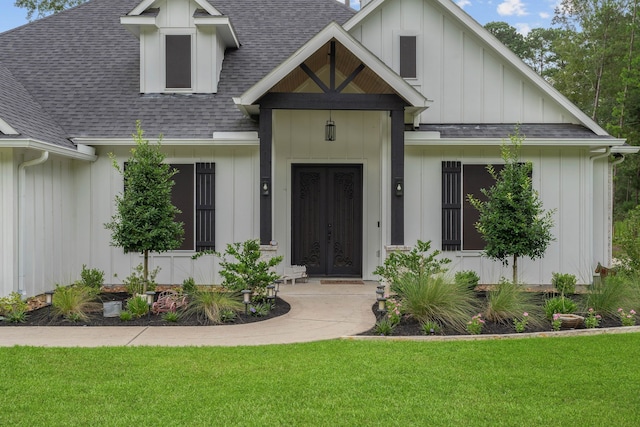 206 Rim Rock Rd, Huntsville, TX 77340 - view of front of house with a shingled roof, board and batten siding, a front lawn, and french doors
