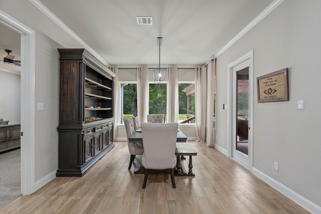 206 Rim Rock Rd, Huntsville, TX 77340 - dining space featuring light wood finished floors and ornamental molding
