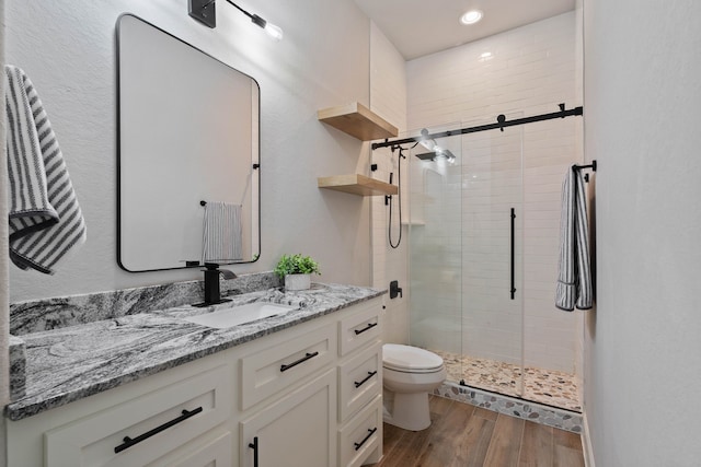 206 Rim Rock Rd, Huntsville, TX 77340 - bathroom featuring vanity, a shower stall, wood finished floors, and recessed lighting