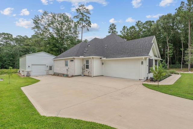 206 Rim Rock Rd, Huntsville, TX 77340 - view of front facade featuring board and batten siding, a shingled roof, a front lawn, and an outdoor structure