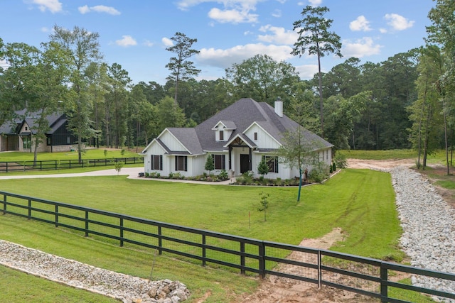 206 Rim Rock Rd, Huntsville, TX 77340 - view of front of house with board and batten siding, a chimney, driveway, and roof with shingles
