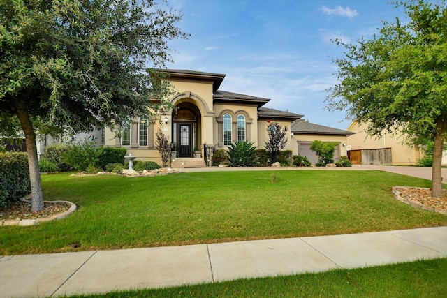 2728 Long Lasso Pass, Leander, TX 78641 - mediterranean / spanish-style home with driveway, a front lawn, a garage, and stucco siding