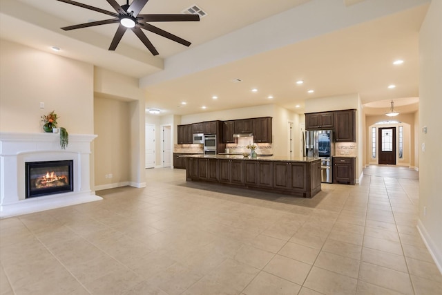 2728 Long Lasso Pass, Leander, TX 78641 - living room with light tile patterned floors, a ceiling fan, recessed lighting, and a glass covered fireplace