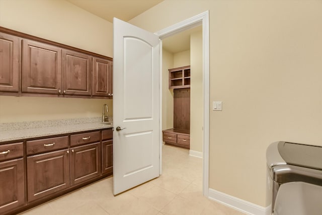 2728 Long Lasso Pass, Leander, TX 78641 - laundry room featuring cabinet space, wet bar, and light tile patterned floors