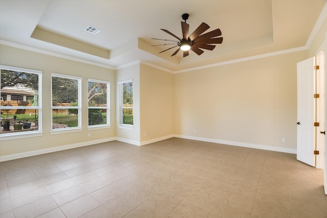 2728 Long Lasso Pass, Leander, TX 78641 - tiled empty room featuring a tray ceiling, healthy amount of natural light, a ceiling fan, and ornamental molding