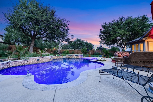 2728 Long Lasso Pass, Leander, TX 78641 - pool at dusk featuring a fenced backyard, a patio area, and a pool with connected hot tub