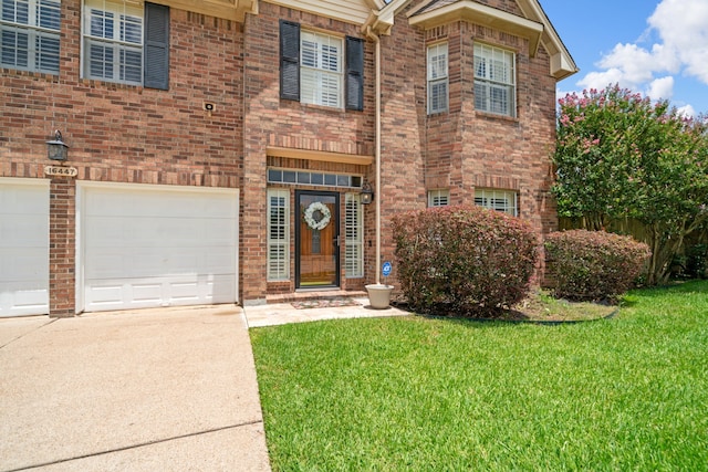 16447 Flint Run Way, Sugar Land, TX 77498 - view of front of property with driveway, a front yard, brick siding, and an attached garage