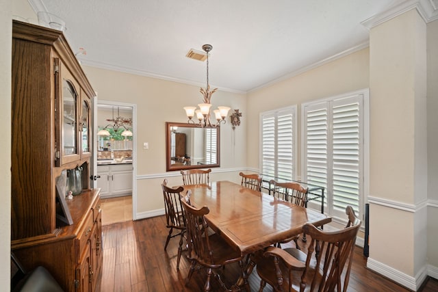 16447 Flint Run Way, Sugar Land, TX 77498 - dining space with dark wood-type flooring, crown molding, and a chandelier