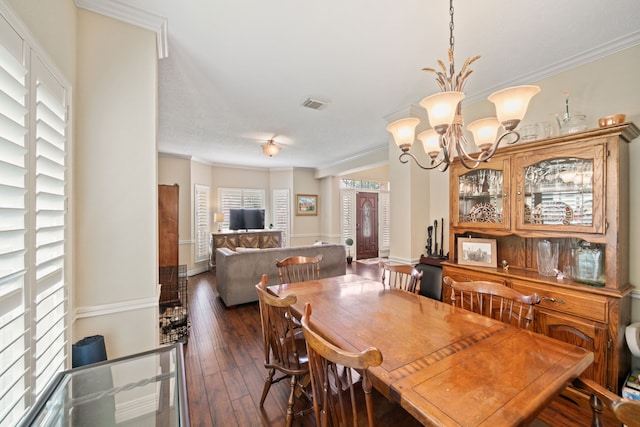 16447 Flint Run Way, Sugar Land, TX 77498 - dining area featuring dark wood-style flooring, a chandelier, and crown molding