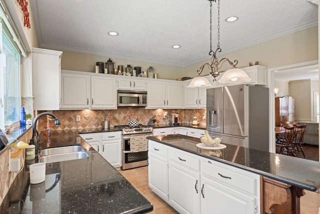 16447 Flint Run Way, Sugar Land, TX 77498 - kitchen featuring stainless steel appliances, white cabinets, decorative backsplash, a kitchen island, and recessed lighting