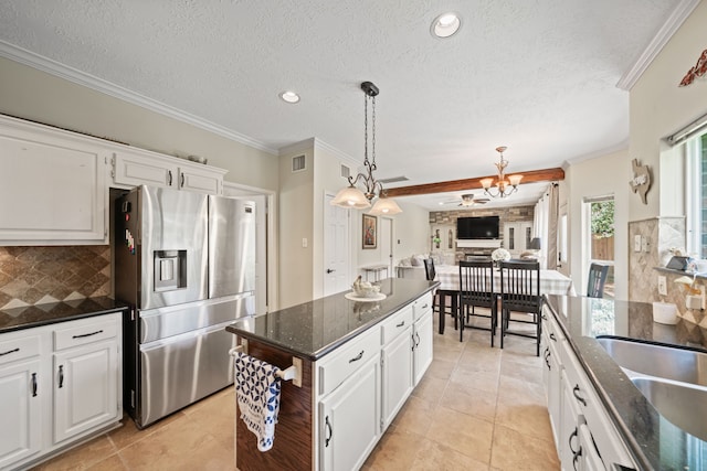 16447 Flint Run Way, Sugar Land, TX 77498 - kitchen with stainless steel refrigerator with ice dispenser, tasteful backsplash, white cabinetry, a chandelier, and dark stone counters