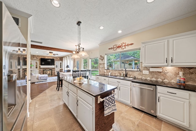 16447 Flint Run Way, Sugar Land, TX 77498 - kitchen featuring dishwasher, decorative backsplash, a textured ceiling, recessed lighting, and white cabinetry