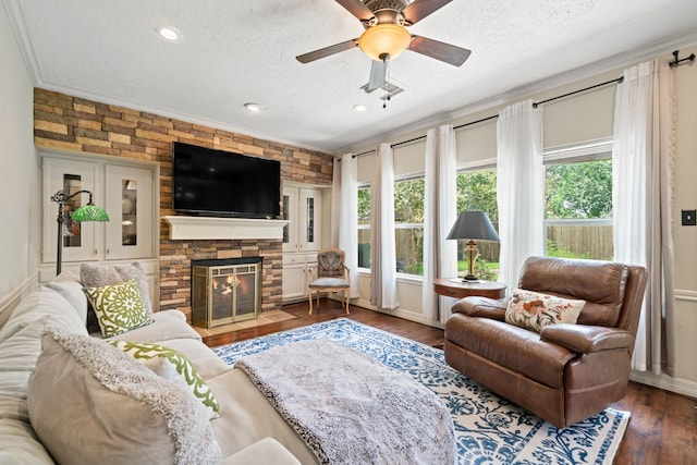 16447 Flint Run Way, Sugar Land, TX 77498 - living room featuring a textured ceiling, a stone fireplace, wood finished floors, a ceiling fan, and recessed lighting