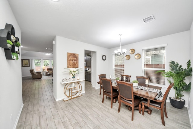 5206 Wyatt James Ln, Brookshire, TX 77423 - dining area featuring a chandelier and light wood-style floors