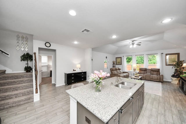5206 Wyatt James Ln, Brookshire, TX 77423 - kitchen featuring open floor plan, ceiling fan, stainless steel dishwasher, a center island with sink, and light wood-style flooring