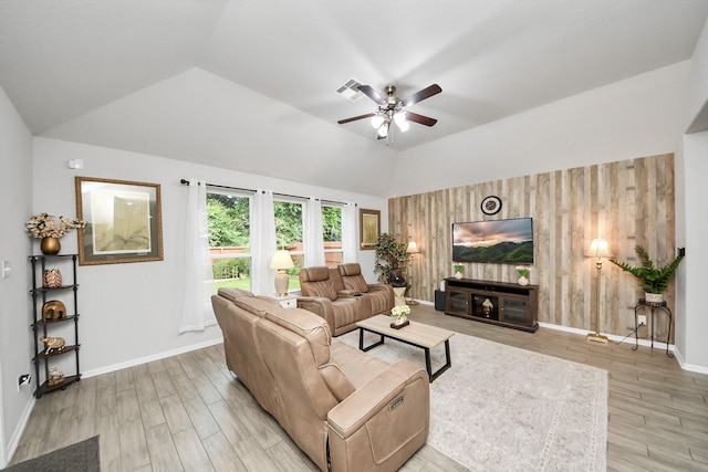 5206 Wyatt James Ln, Brookshire, TX 77423 - living room with ceiling fan, vaulted ceiling, light wood-style flooring, and wooden walls