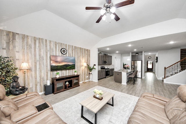 5206 Wyatt James Ln, Brookshire, TX 77423 - living room with vaulted ceiling, stairway, a ceiling fan, wooden walls, and light wood finished floors