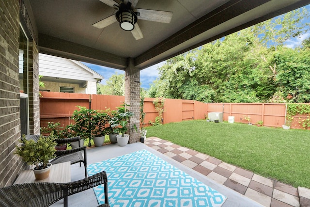 5206 Wyatt James Ln, Brookshire, TX 77423 - fenced backyard with a ceiling fan and a patio