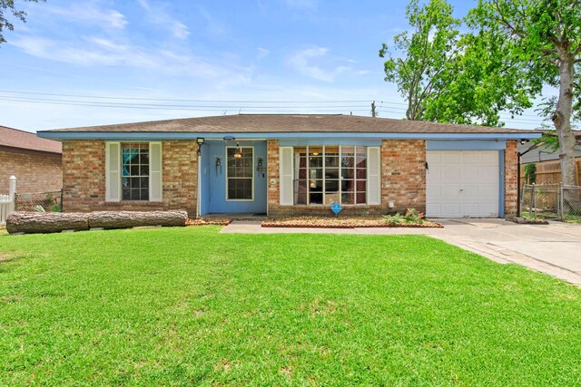 15050 Groveshire St, Channelview, TX 77530 - ranch-style house featuring driveway, a garage, and brick siding