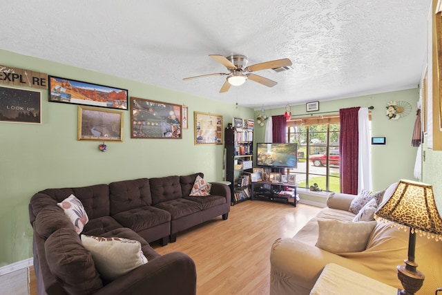 15050 Groveshire St, Channelview, TX 77530 - living area featuring a ceiling fan, wood finished floors, and a textured ceiling