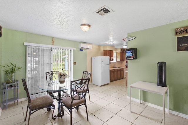 15050 Groveshire St, Channelview, TX 77530 - dining space featuring an AC wall unit, light tile patterned floors, and a textured ceiling