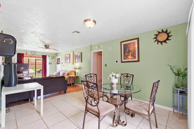 15050 Groveshire St, Channelview, TX 77530 - dining room with ceiling fan, light tile patterned floors, and a textured ceiling